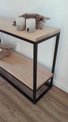 a wooden table with two candles on it