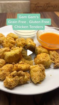 a white plate topped with fried chicken nuggets and dipping sauce on the side