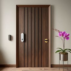 a wooden door with an electronic lock on it and a potted plant next to it