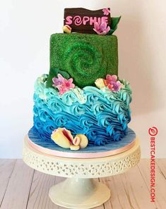 a multi - layered cake with blue and green frosting