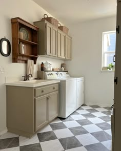 a kitchen with a checkered floor and cabinets