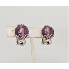 This is part of Chairish’s Costume Jewelry assortment.  Circa 1960 rhodium plated faceted disco ball-like faux-amethyst clip back earrings. Marked "Napier." Measure: 1 1/16 inches long by 13/16 inches wide. Condtion: Very good; a tiny amount of wear only noticeable upon very close inspection.  Please reference the measurements noted in the description above for the best approximate dimensions. Please reach out to the seller under "Ask the Seller" for specific questions regarding the measurements Formal Purple Clip-on Jewelry, Purple Clip-on Earrings For Formal Occasions, Purple Clip-on Earrings, Modern Branding, Accessories Jewelry Earrings, Clip Earrings, Disco Ball, Vintage Signs, Rhodium Plated