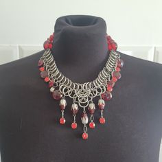 This is a brutalist and gothic style necklace with red beads A beautiful statement piece good used condition Shipping is registered and tracked I can combine shipping for multiple items message me if you need this Check out other vintage jewelry at my shop Red Chain Choker Necklace, Red Metal Jewelry With Beaded Chain, Red Metal Beaded Necklace For Party, Red Beaded Metal Necklace For Party, Party Red Metal Beaded Necklace, Vintage Red Chain Necklace, Red Beaded Metal Necklace, Gothic Red Chain Necklace, Gothic Red Necklace With Chain