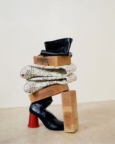 a stack of socks and boots sitting on top of each other