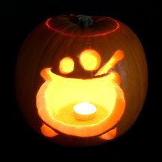 a carved pumpkin with a lit candle in it