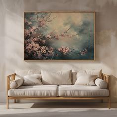 a painting hanging on the wall above a couch