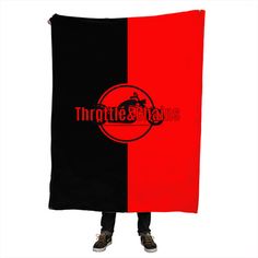 a man is holding up a black and red blanket with the word thronite titans on it