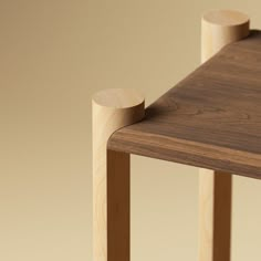 a close up of a wooden table with two round knobs on the top and bottom