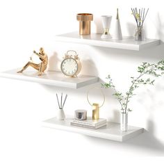 two white shelves with vases, clock and plants