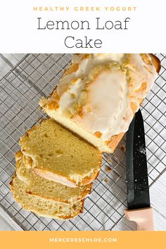 a loaf of lemon loaf cake sitting on top of a cooling rack next to a knife