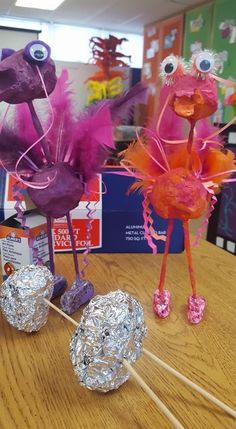 some candy lollipops are sitting on a table and one is made to look like a bird