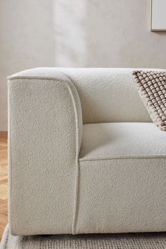 a white couch sitting on top of a wooden floor