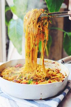 someone is eating noodles with chopsticks in a bowl