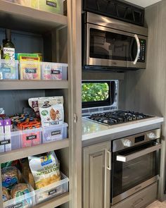 a kitchen with an oven, microwave and shelves full of food in the pantry area