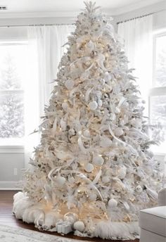 a white christmas tree in a living room