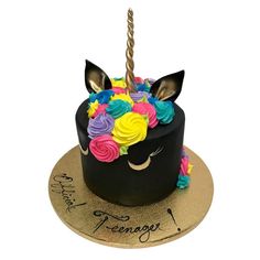 a birthday cake decorated with flowers and a unicorn's head