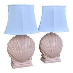 two pink seashell lamps with shades on them