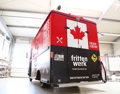 a red and black truck parked in a garage