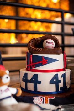 a three tiered cake decorated with baseballs and mitts