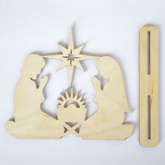 a wooden cutout of a nativity scene with the birth of jesus