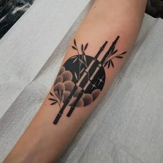 a black and white tattoo on the arm of a person with chopsticks in front of an umbrella