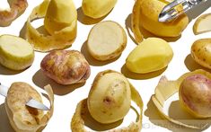 several pieces of potato sitting on top of a white surface next to a pair of scissors