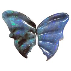 an opalite butterfly shaped broochle is shown in this image, the wings are