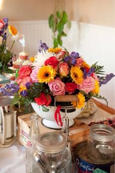 a table topped with lots of different types of flowers