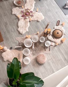 an overhead view of a dining room table with dishes and utensils