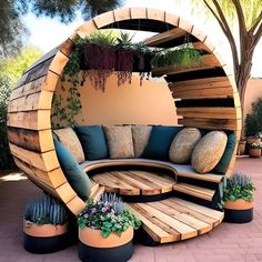 an outdoor couch made out of wood and plants