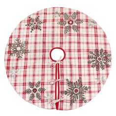 a red and white plaid christmas tree skirt with snowflakes on it, hanging from the side