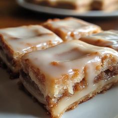 three pieces of glazed dessert sitting on top of a white plate next to each other