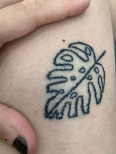 a close up of a person's leg with a tattoo design on the side