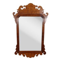 a wooden mirror sitting on top of a white wall