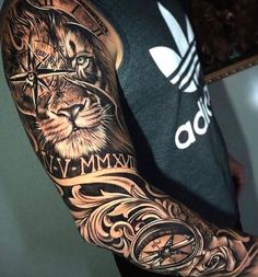 a man's arm with a lion tattoo on it and an adidas t - shirt