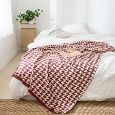 a bed covered in a red and white blanket