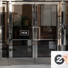 an open glass door with the word push written on it