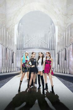 four girls are standing in front of a pipe organ with their arms around each other