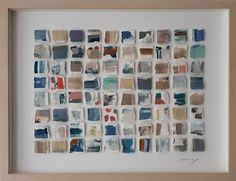 a white framed artwork with many different colored squares