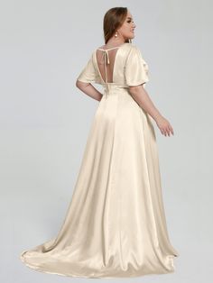 the back of a woman wearing a long dress with open shoulders and an open back