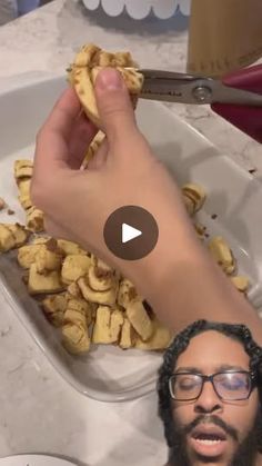 a man with glasses is eating food in a sink