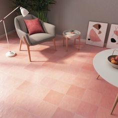 a living room filled with furniture and pink tiles on the floor next to a white coffee table