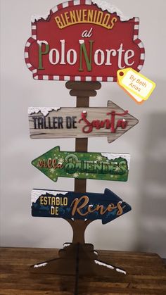 a wooden sign with many different signs on it's sides and the words in spanish