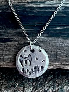 The elusive Mothman is hand-stamped to order on a solid 3/4 inch or about the size of a penny pewter pendant which hangs from a 20 inch stainless steel chain. Each pendant is made to order and will slightly vary from one another, but all will have trees, stars and a mysterious feel! Production time is 14 to 21 business days not including Saturdays, Sundays or postal holidays. Cryptidcore Jewelry, Cryptid Jewelry, Cryptid Clothes, Cryptid Aesthetic Outfit, Mothman Tattoo, Cool Jewelry, Lovers Necklace, Pagan Jewelry, Pewter Pendant