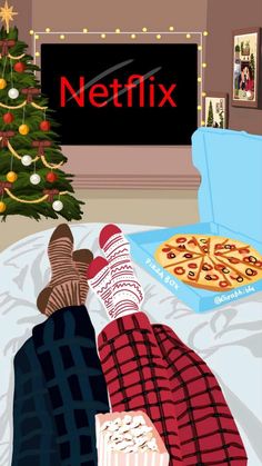 a person laying on a bed in front of a christmas tree and a pizza box