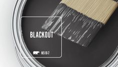 a paint can with a brush in it and the words blackout on top of it