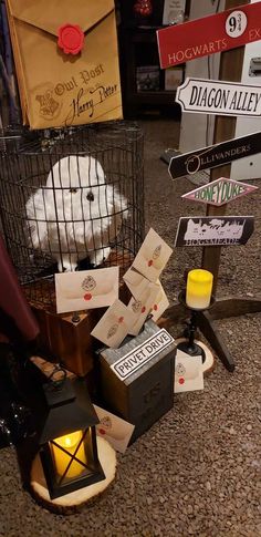 a bunch of signs that are sitting on the ground in front of a birdcage