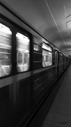 black and white photograph of subway train passing by