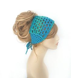 a woman's head wearing a blue crochet hat