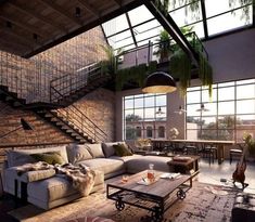 a living room filled with lots of furniture and plants hanging from the ceiling above it